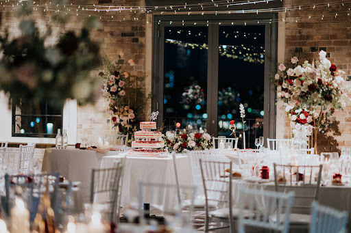 Wedding tables, floral styling, and cake inside Watersedge